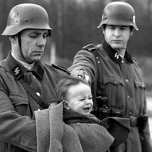 It took me a millisecond too long to see what the Nazi on the right held in his right hand. Murder is easy if you're an antisemite.