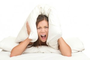 overwhelmed person with pillow over her head