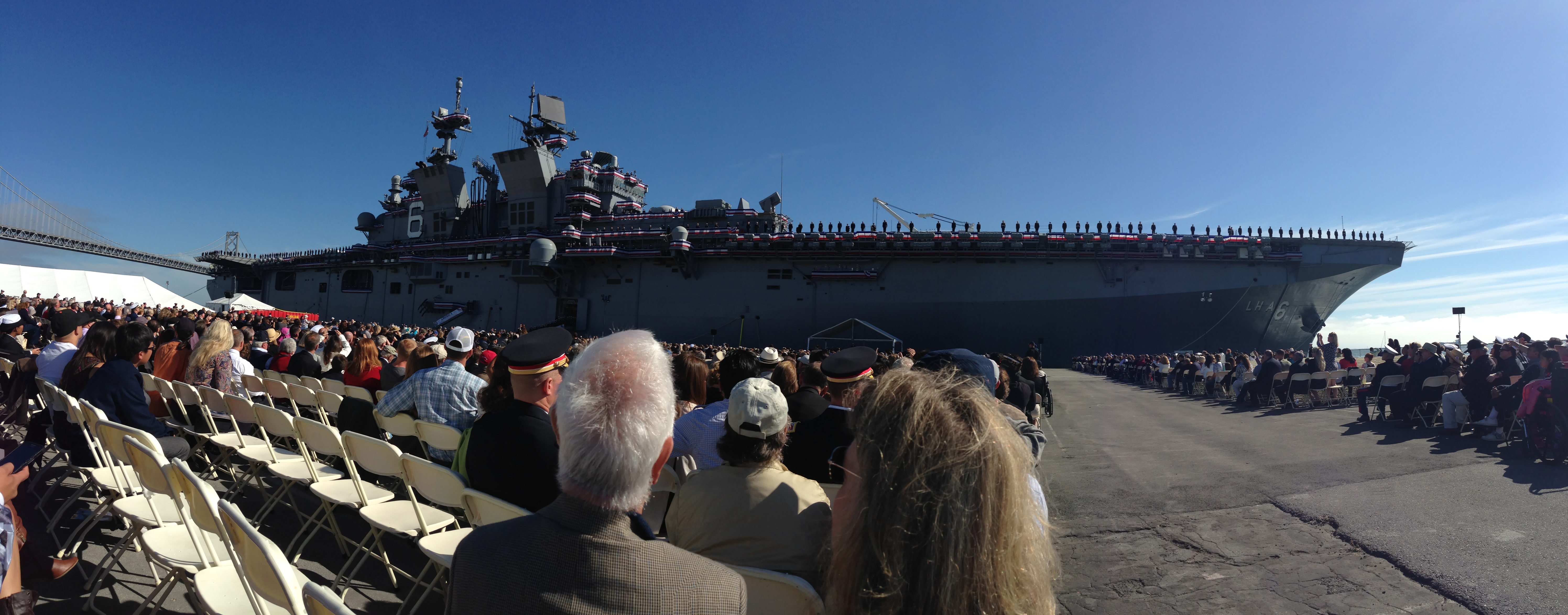 The crew mans the port side of the USS America, having brought the ship to life at its commissioning.