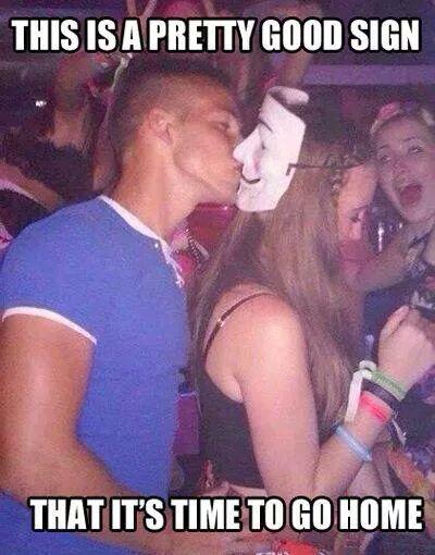 Silly Drunk man kisses mask on back of woman's head