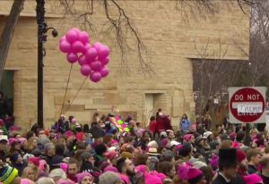 Pink-hatted marching women