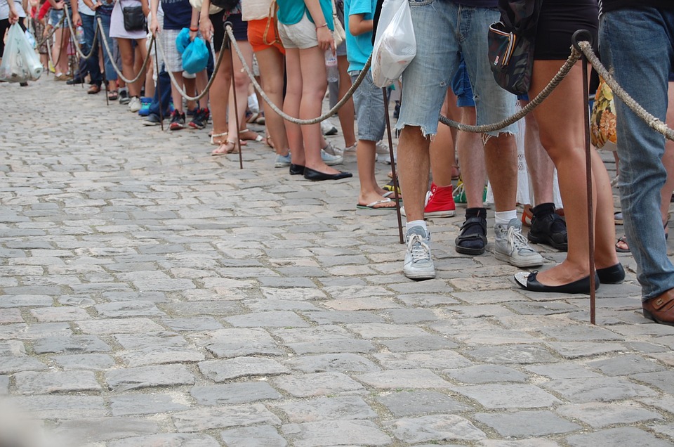 People standing in line illegal immigration analogy